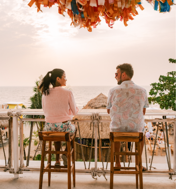 Two people sharing dinner on the rooftop at Beverly Beach Garden